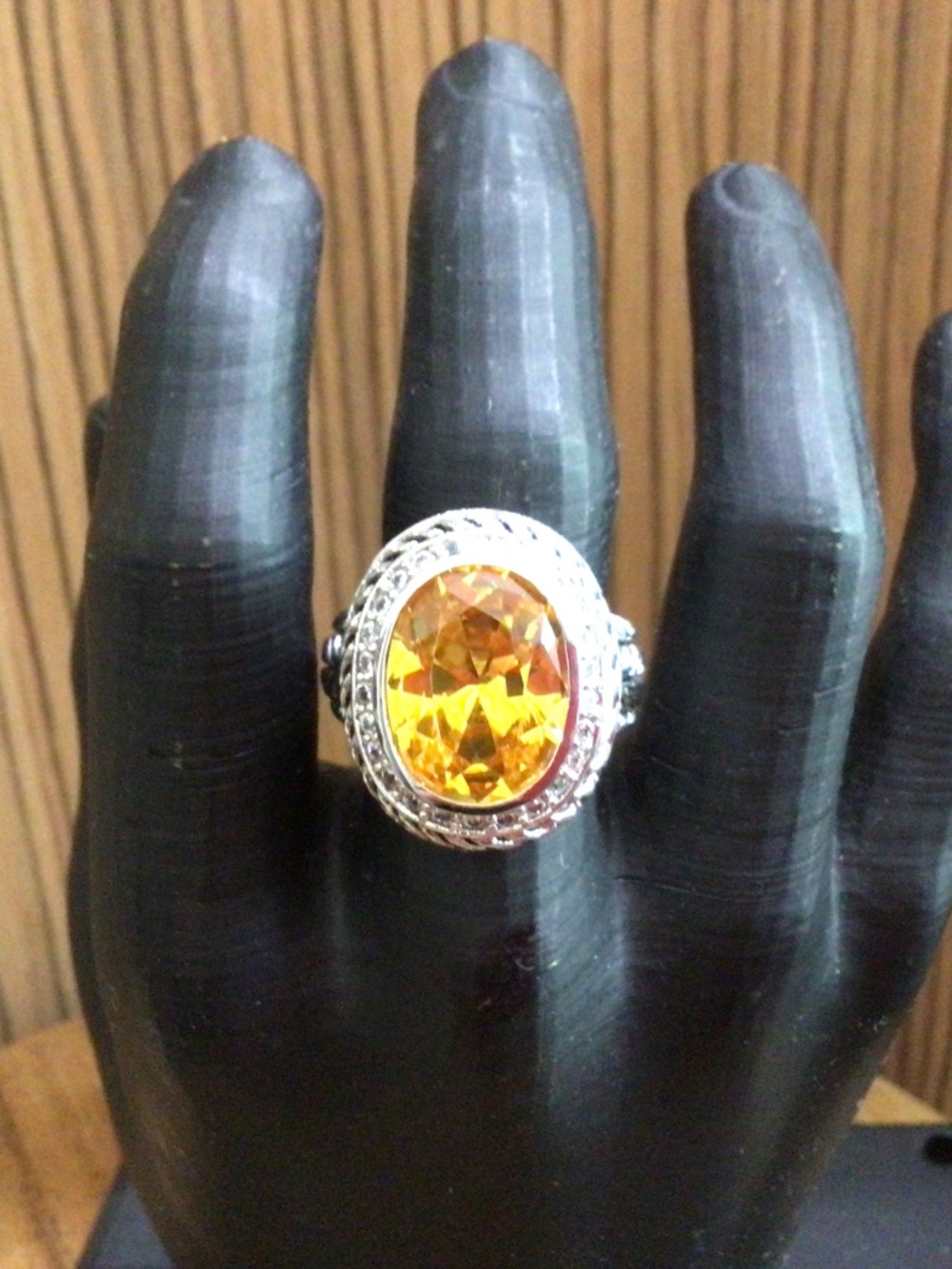 Large topaz colored stone, surrounded by clear rhinestone ring. Size 9
